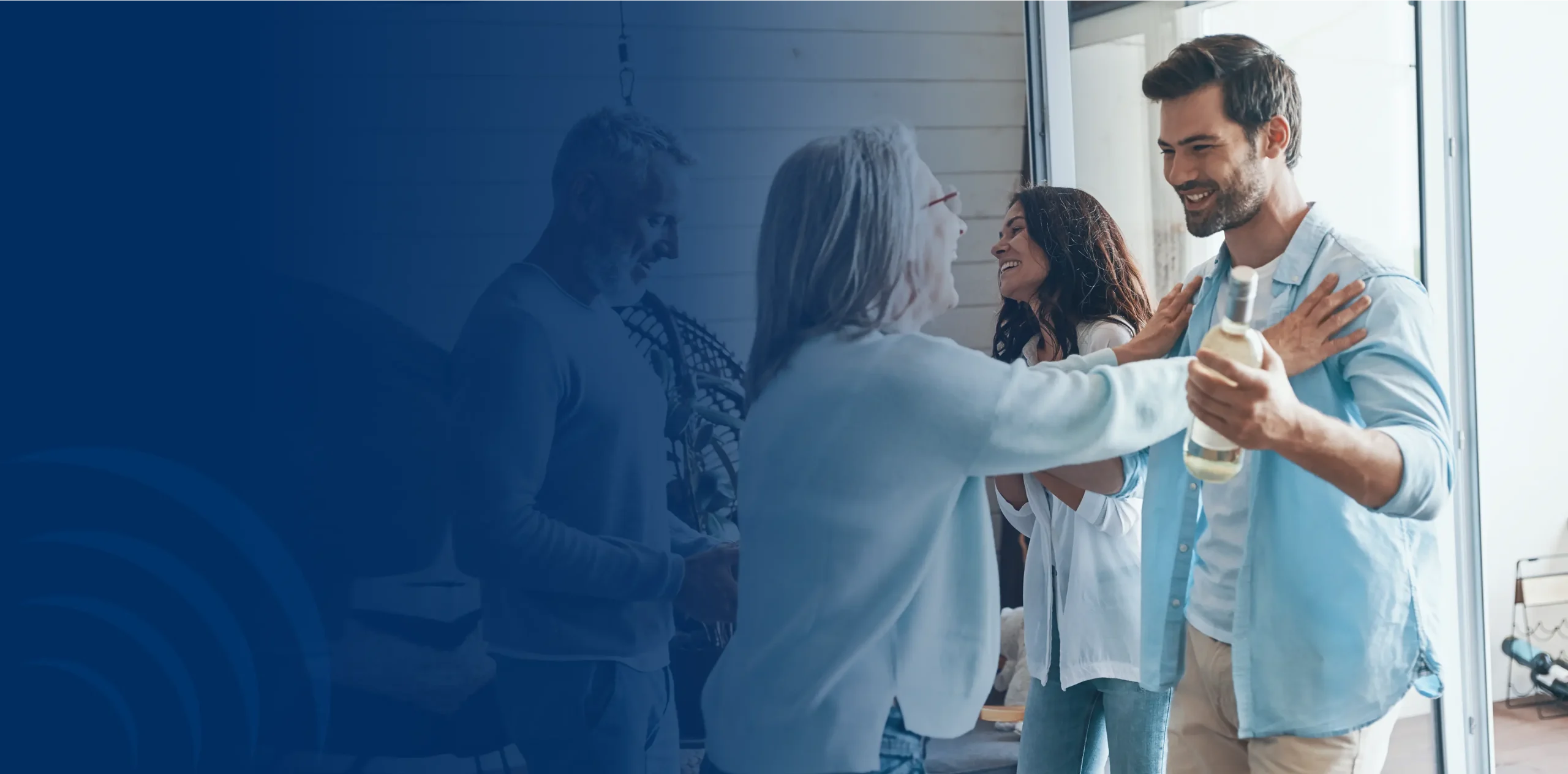 Family members welcoming each other with hugs and smiles