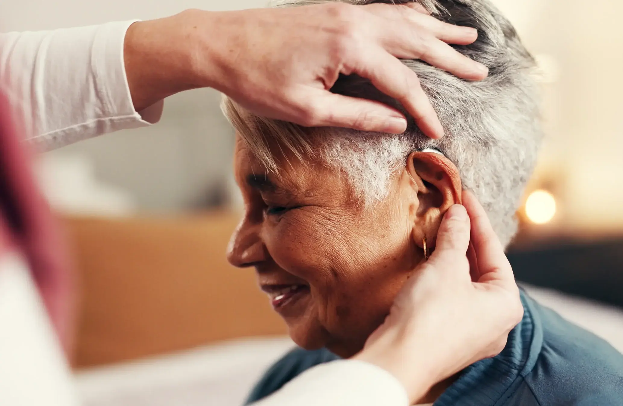 Audiologist performing real ear measurement test on a patient wearing hearing aids